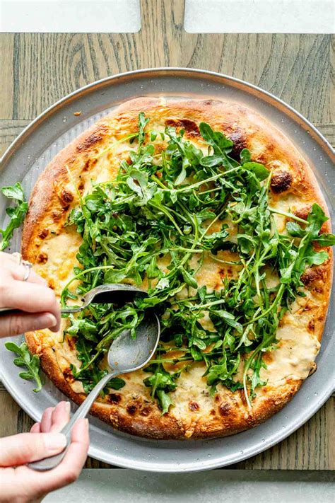 when to put arugula on pizza  Roll out dough thinly, to form pizza crust